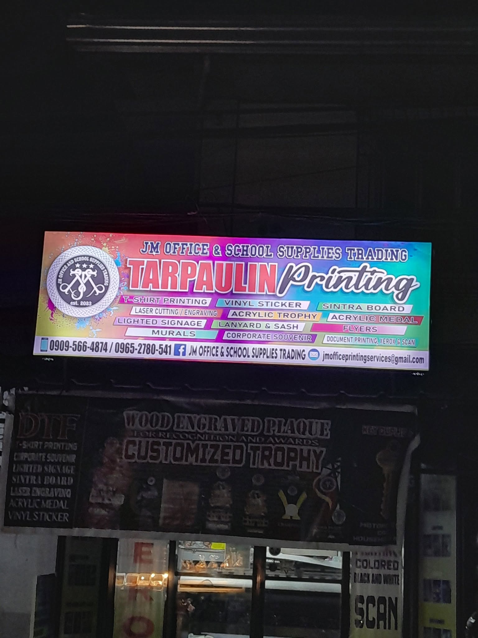 JM lightened signage outside their business establishment